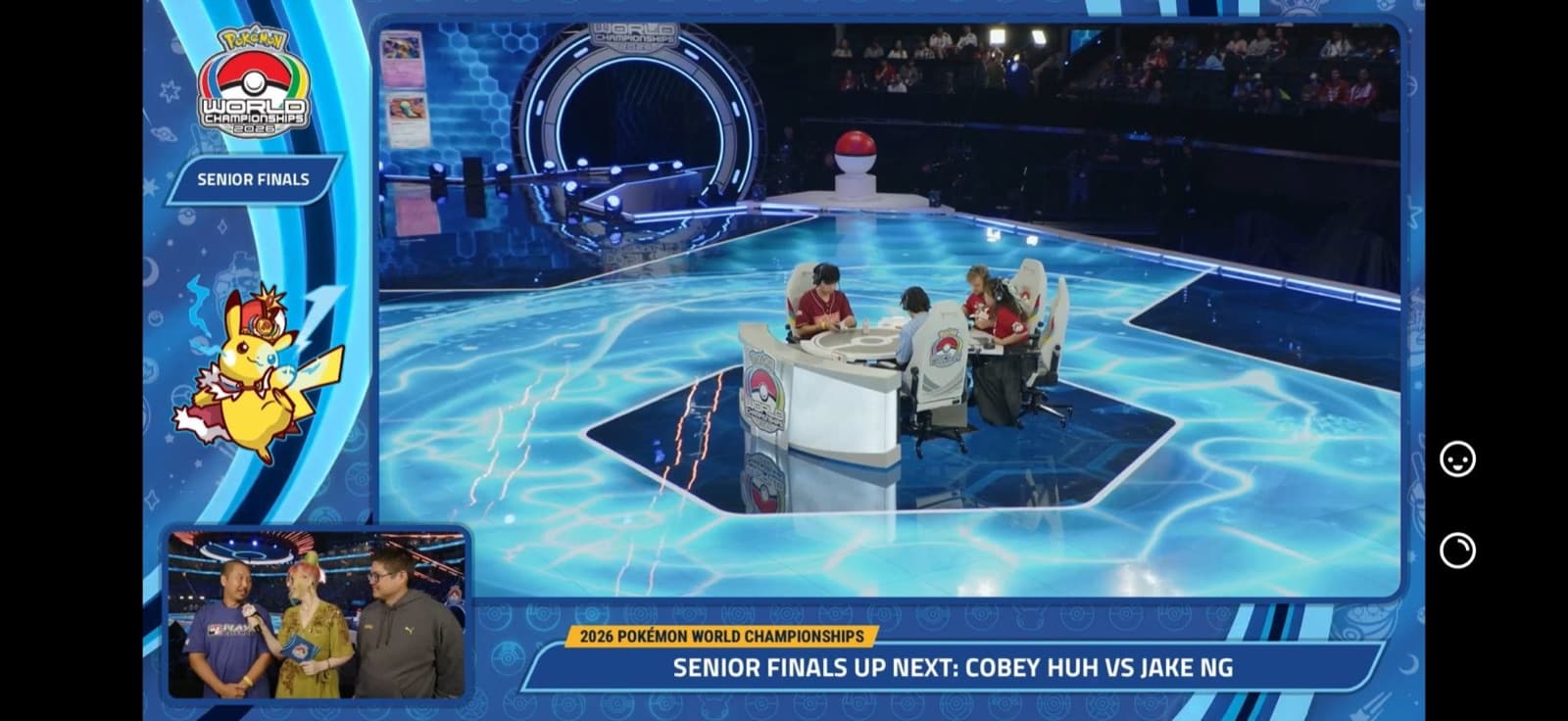 An arena screen reading Senior Finals up next, Cobey Huh versus Jake Ng